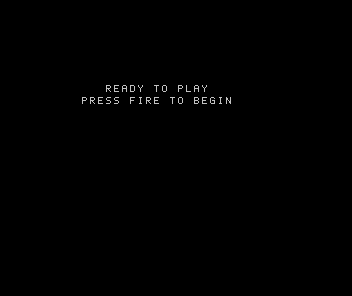 An original READY TO PLAY prompt and PRESS FIRE TO BEGIN line centred within the declared panel on Spectrum 48K.