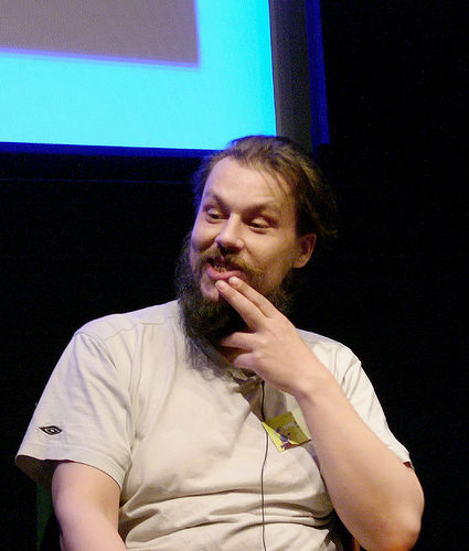 Matthew Smith seated on stage during his Screenplay appearance in 2005