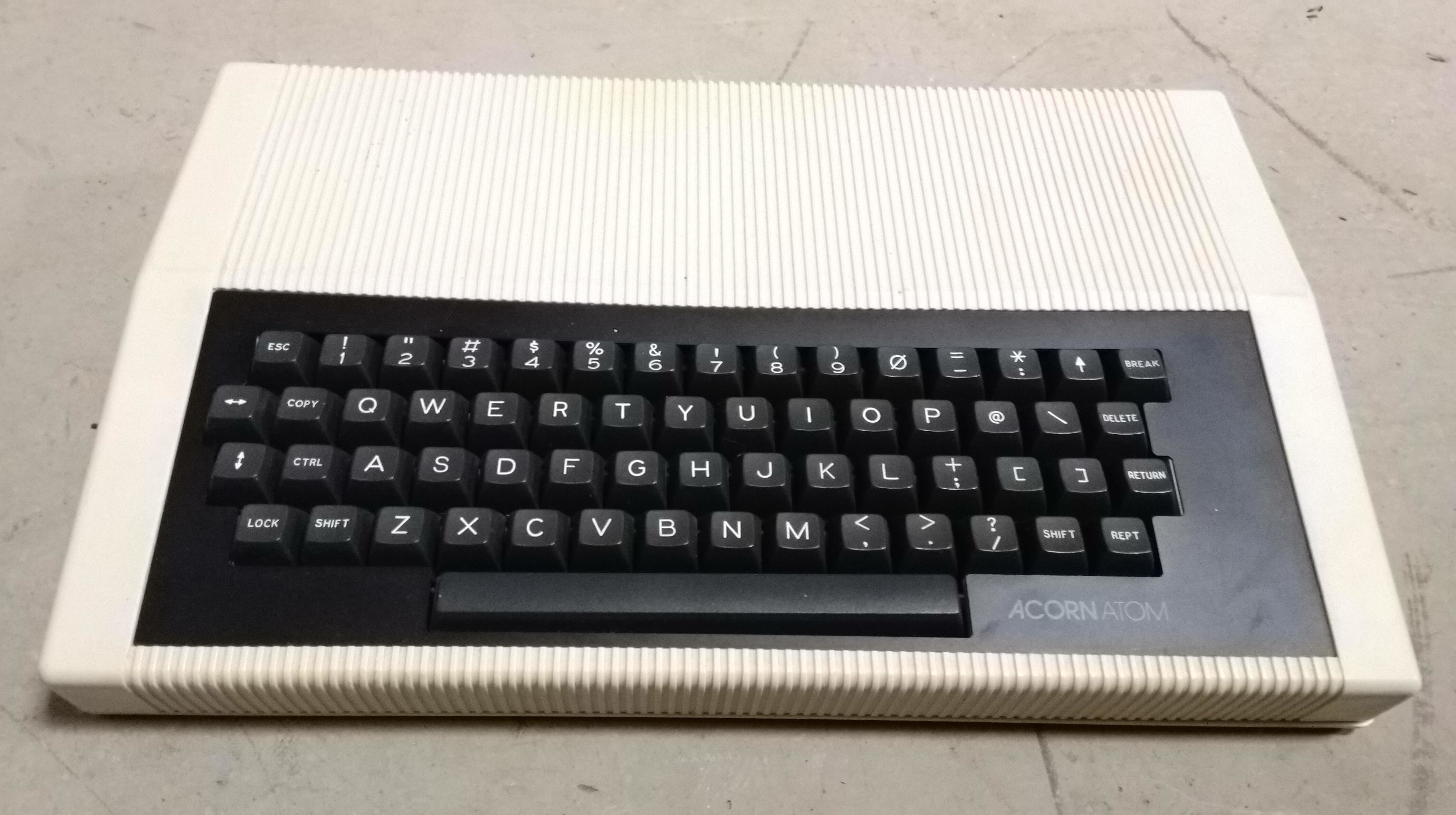 An Acorn Atom in its cream case, with a full QWERTY keyboard, space bar and a Break key at the upper right